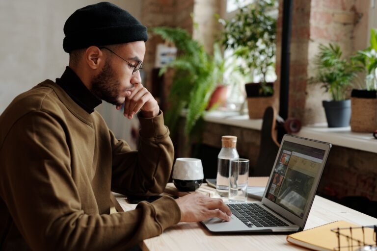 Freelancer working remotely on a laptop in a cozy workspace