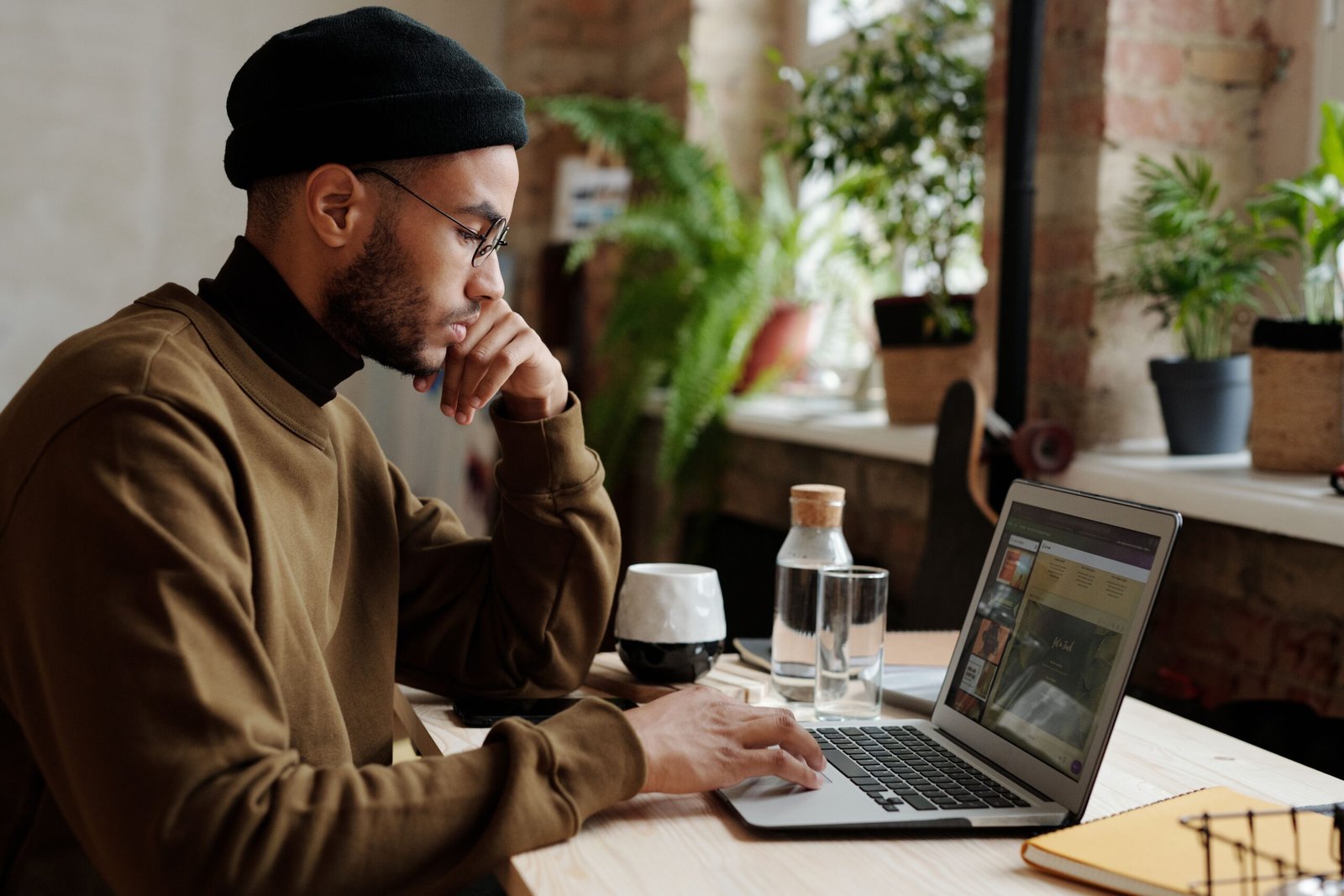 Freelancer working remotely on a laptop in a cozy workspace